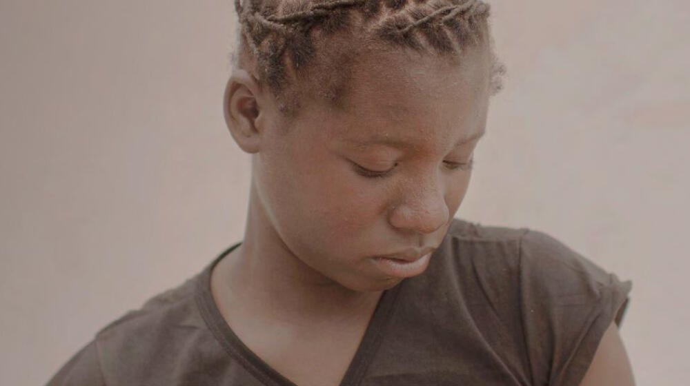 A girl looks down.