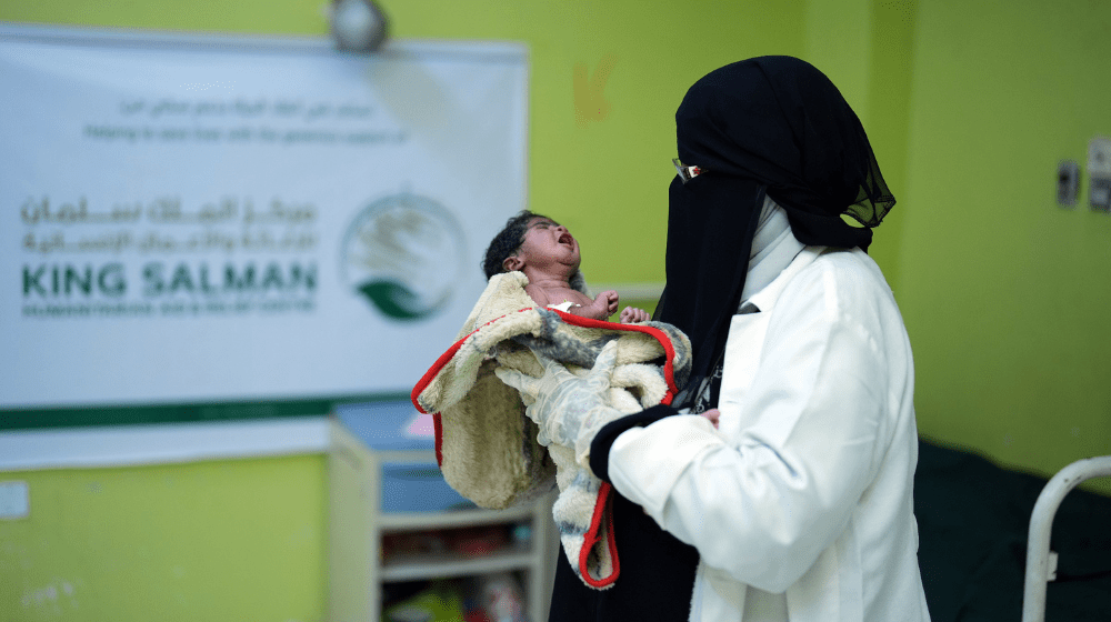 A midwife holds a newborn.