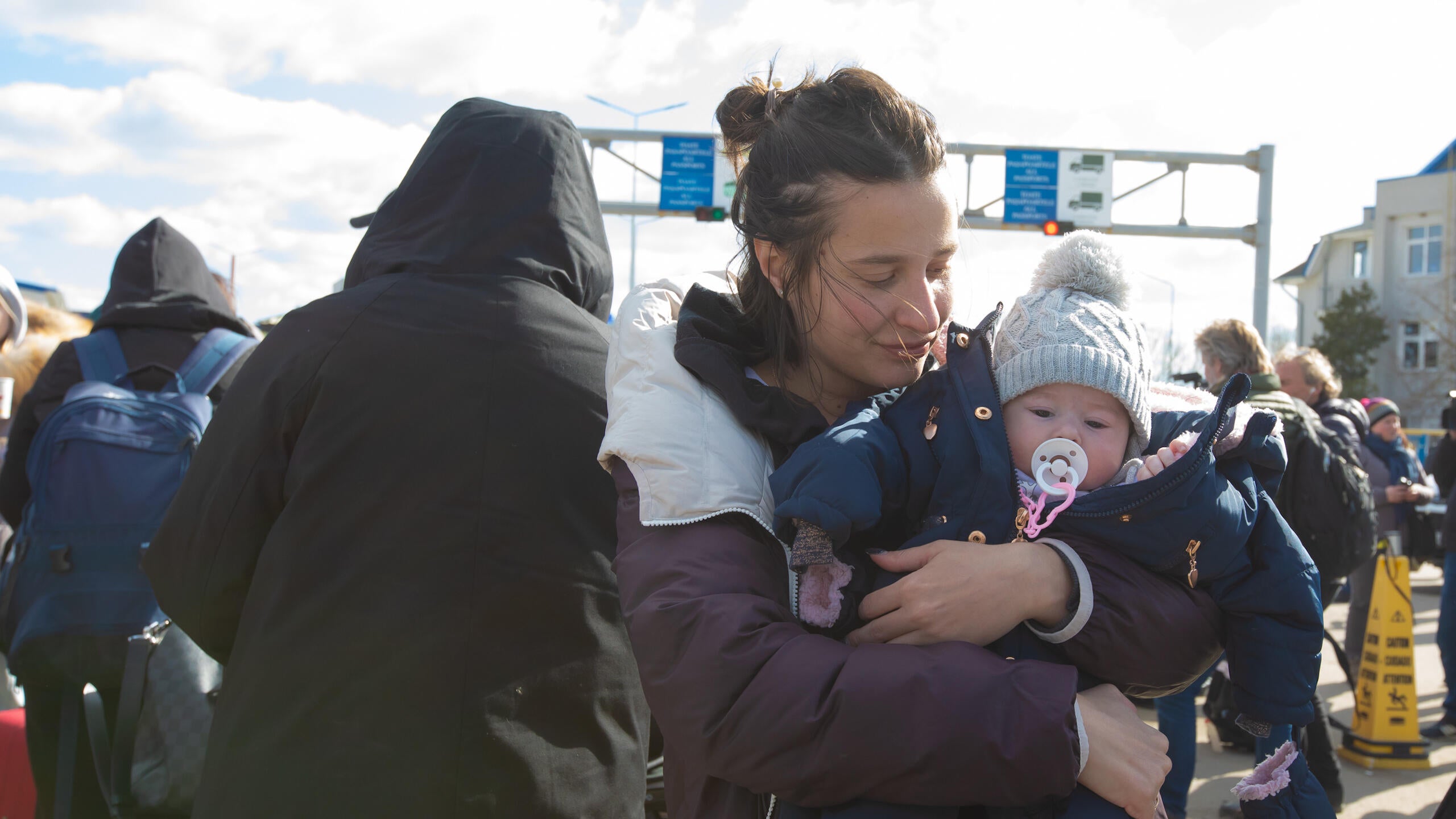 A mother holds her young child.